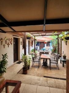 an outdoor patio with a table and chairs at Tía Mema Hostal in Santa Ana