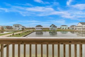 a view from the balcony of a house with a pond at Born To Beach home in Crystal Beach