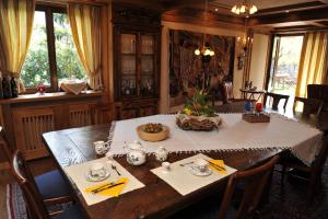 a dining room with a table with a white table cloth at Bonavia B&B in Sistiana +14 photos