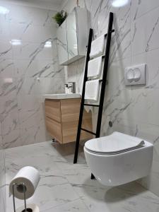 a white bathroom with a toilet and a sink at Apartments Cvitanović Korčula in Korčula +20 photos