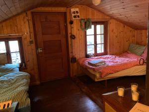 a small room with two beds in a cabin at Chalet La Paz with Hotpot and Sauna in Törbel