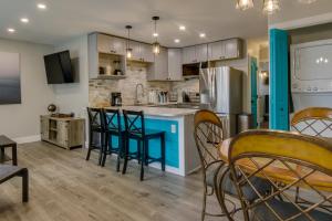 a kitchen and dining room with chairs and a table at Walk to Beach and Boardwalk Ocean City Condo in Ocean City