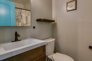 a bathroom with a white sink and a toilet at Walk to Beach and Boardwalk Ocean City Condo in Ocean City +17 photos