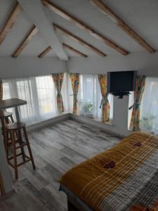 a bedroom with a bed and a flat screen tv at Casa in Craiova