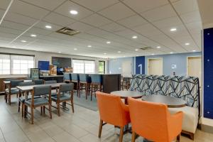 a waiting room with tables and chairs in a store at Holiday Inn Express I-95 Capitol Beltway - Largo, an IHG Hotel in Largo