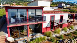 an aerial view of a house with large glass windows at Victoria Tiny Stone House in Ponta do Pargo