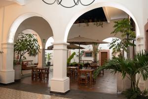 an outdoor patio with tables and chairs and umbrellas at Hotel Catedral in Cuernavaca +120 photos