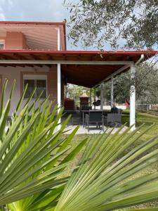 a patio with awning on a house at Seaside House in Karianí