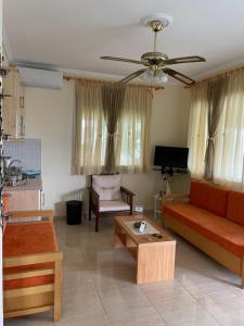 a living room with a couch and a ceiling fan at Seaside House in Karianí