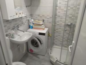 a bathroom with a washing machine and a washer at Apartments Jovanović in Perast