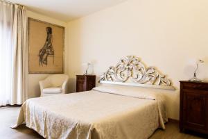 ピエーヴェ・ディ・ソリーゴにあるLocanda Da Linoのベッドルーム(白いベッド1台、椅子付)