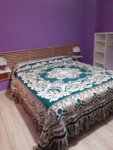 a bed with a blanket on it in a room at La Casa di Romeo in Ateleta
