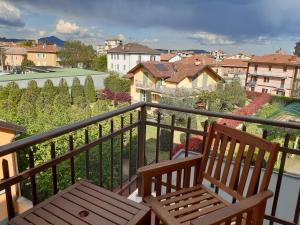 a balcony with a bench and a view of a city at Giaveno, apartment "margherita" a pochi passi dal centro, wifi in Giaveno