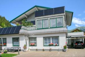 a house with solar panels on the roof at Apartment Birke 2 - by Alpen Apartments in Bad Gastein