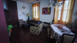 a living room with a table and a couch at Casa Funes in Funes