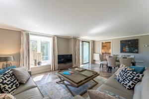 a living room with a couch and a table at Gleneagles Apartment - Guthrie Court Gleneagles in Auchterarder