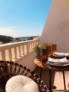 a patio with two tables and chairs on a balcony at Villa Mili in Hvar