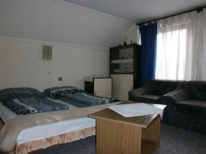 A bed or beds in a room at György Vendégház