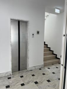 a hallway with a door and stairs in a building at Hotel Exclusive in Riccione