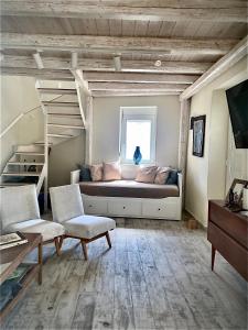a large living room with a couch and stairs at Tranquil chic retreat in Heraklio