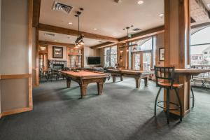 a room with ping pong tables and chairs in it at Buffalo Lodge 8320 in Keystone