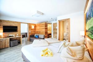 a hotel room with a bed and a couch at Hotel Arnika in Ischgl