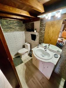 a bathroom with a sink and a toilet at Victoria Tiny Stone House in Ponta do Pargo