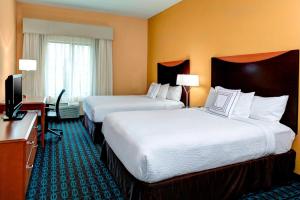 a hotel room with two beds and a desk at Fairfield Inn & Suites by Marriott Anniston Oxford in Oxford