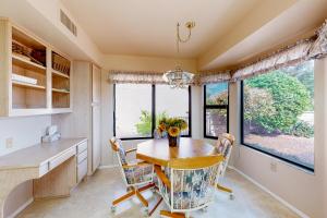 a kitchen with a table and chairs and windows at Sun City Vistoso in Oro Valley