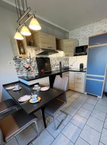 a kitchen with a table with chairs and a blue refrigerator at Ferienwohnung Nordlichter Bremerhaven in Bremerhaven