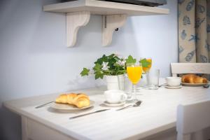 a white kitchen counter with croissants and orange juice at Casa Polo in Rovinj