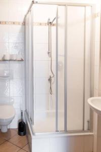 a white bathroom with a shower and a toilet at Ferienhof in Weeze-Wemb in Weeze