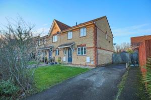 a large brick house with a driveway at Spacious 3 Bedroom Home in Milton Keynes by HP Accommodation - Free Parking, WiFi & Sky TV in Milton Keynes