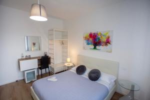 a bedroom with a bed with two pillows and a desk at Bed And Breakfast Castello7 in San Felice del Benaco