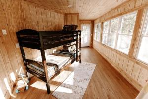 a room with a bunk bed in a cabin at Cabin with Treehouse Views, 3 King Beds, 4 Bunks, and Large Hot Tub! in Gatlinburg