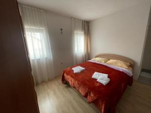 a bedroom with a bed with two towels on it at Maća i Ante Pavlović in Međugorje