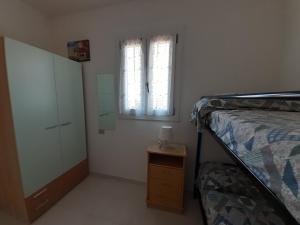 Двох'ярусне ліжко або двоярусні ліжка в номері Appartamento in residence signorile