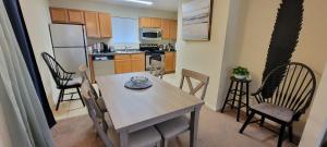 a kitchen with a table and chairs in a room at Prime Location for UF Visitors 2BR Condo with Pool and Fast Wi-Fi in Gainesville