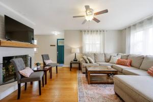 a living room with a couch and a fireplace at Charming DT 3-Bed Bungalow with Fenced-in Yard in Raleigh