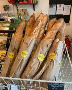 a bunch of breads in bags in a store at Clonbur House - Two bedroom village apartment in Galway