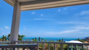 a balcony with a view of the ocean at Red Snapper Guest House in Providencia