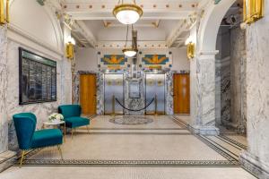 a lobby with two chairs and two elevators at Hotel Gibbs Downtown Riverwalk in San Antonio