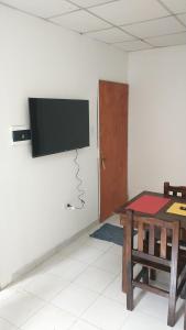 een kamer met een tafel en een flatscreen-tv aan de muur bij Los Cardones - Ruta40 in Chilecito