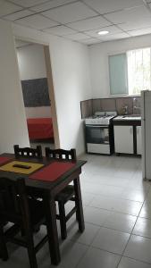 a kitchen with a table and chairs in a room at Los Cardones - Ruta40 in Chilecito