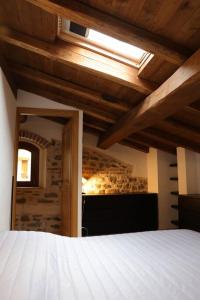 a bedroom with a bed and a wooden ceiling at Villa Maria in Bagnone