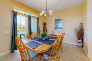 a dining room with a wooden table and chairs at Bear Trap Dunes - 58A October Glory Ave in Ocean View