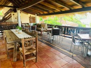 un restaurante con mesas y sillas en una terraza en Casa Manzanillo - Bridge Room - Ocean View Room at Exceptional Beach Front Location, en Troncones
