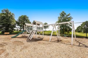 a playground with a slide and a swing at Bear Trap Dunes - 58A October Glory Ave in Ocean View
