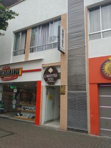 a store front of a building with a storefront at Hotel Cafetto in Pereira