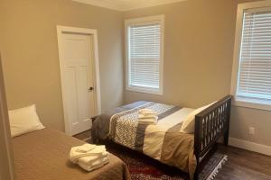 a bedroom with two beds and two windows at 7 Min from Broadway! 3 Bed 2.5 Bath (Sleeps 10+) in Nashville